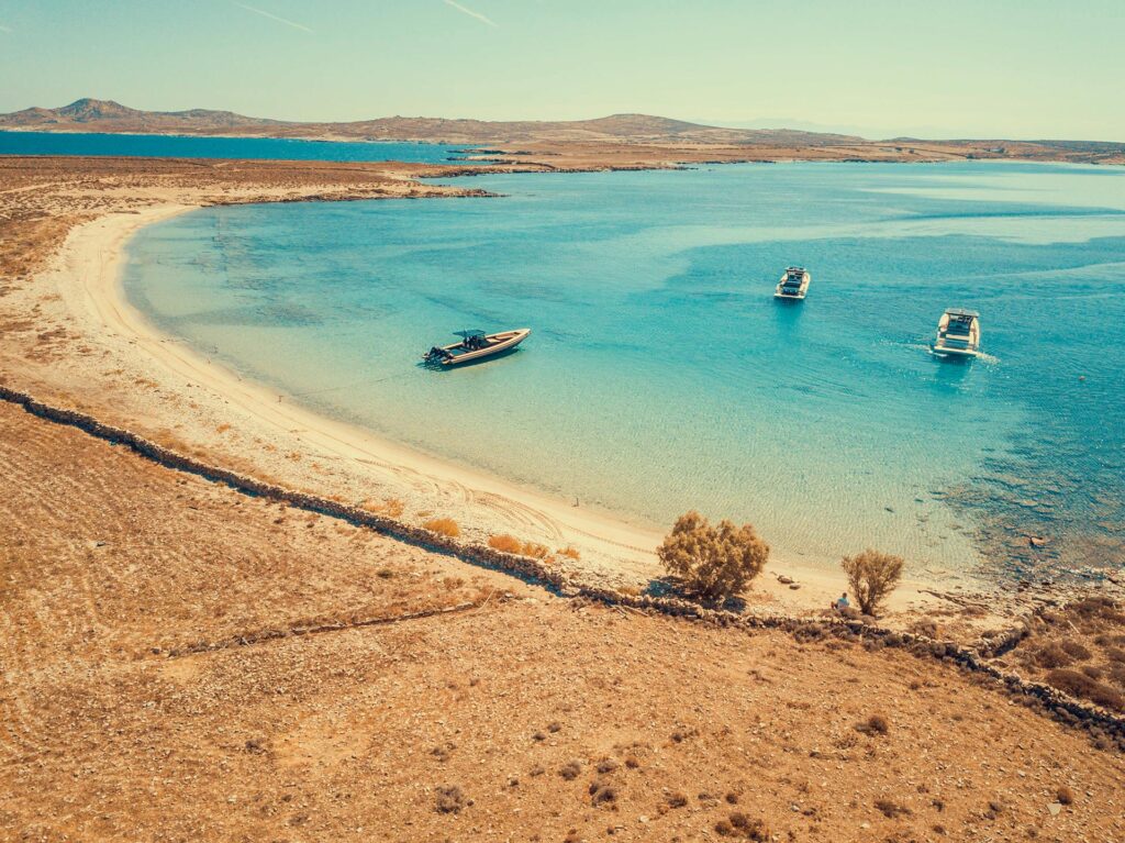 The breathtaking, unspoiled beauty of Rhenia island’s coast, a hidden gem for a private swim away from Mykonos crowds.