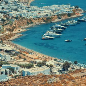 Luxury RIB boat anchored at the world-famous Psarou, one of the top Mykonos beaches for high-end lifestyle and crystal waters.