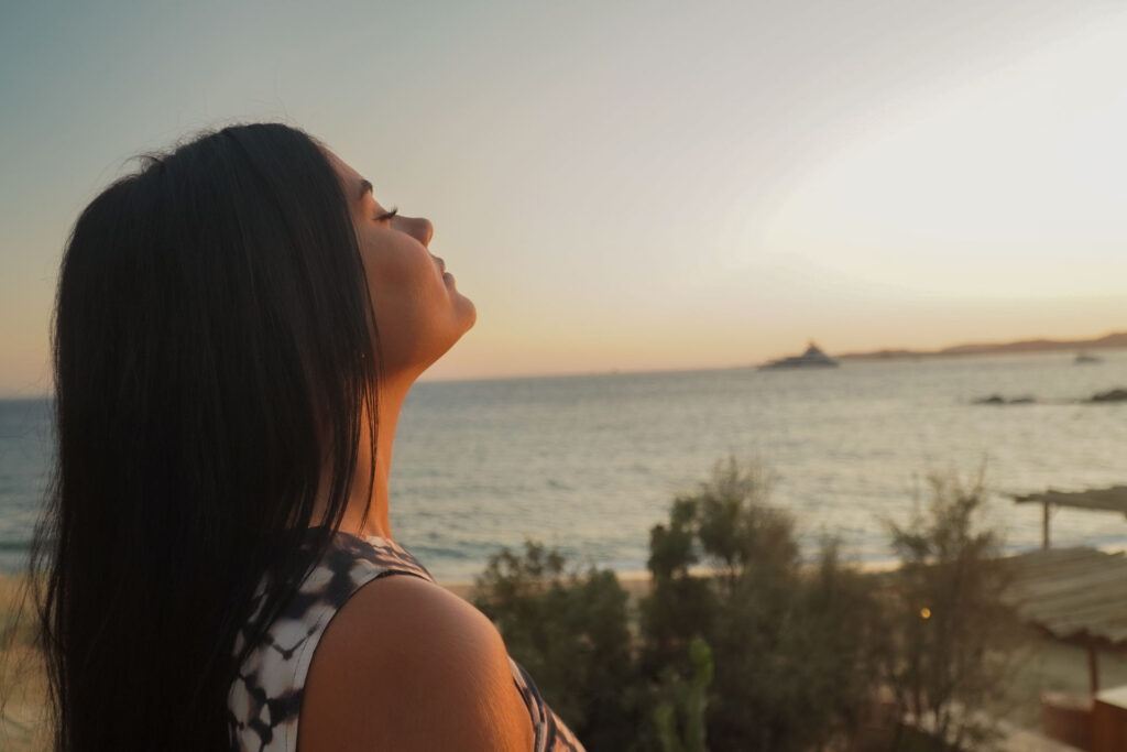 A guest enjoying the iconic sunset at Scorpios Mykonos after a luxury day cruise with Don Blue Yachting.