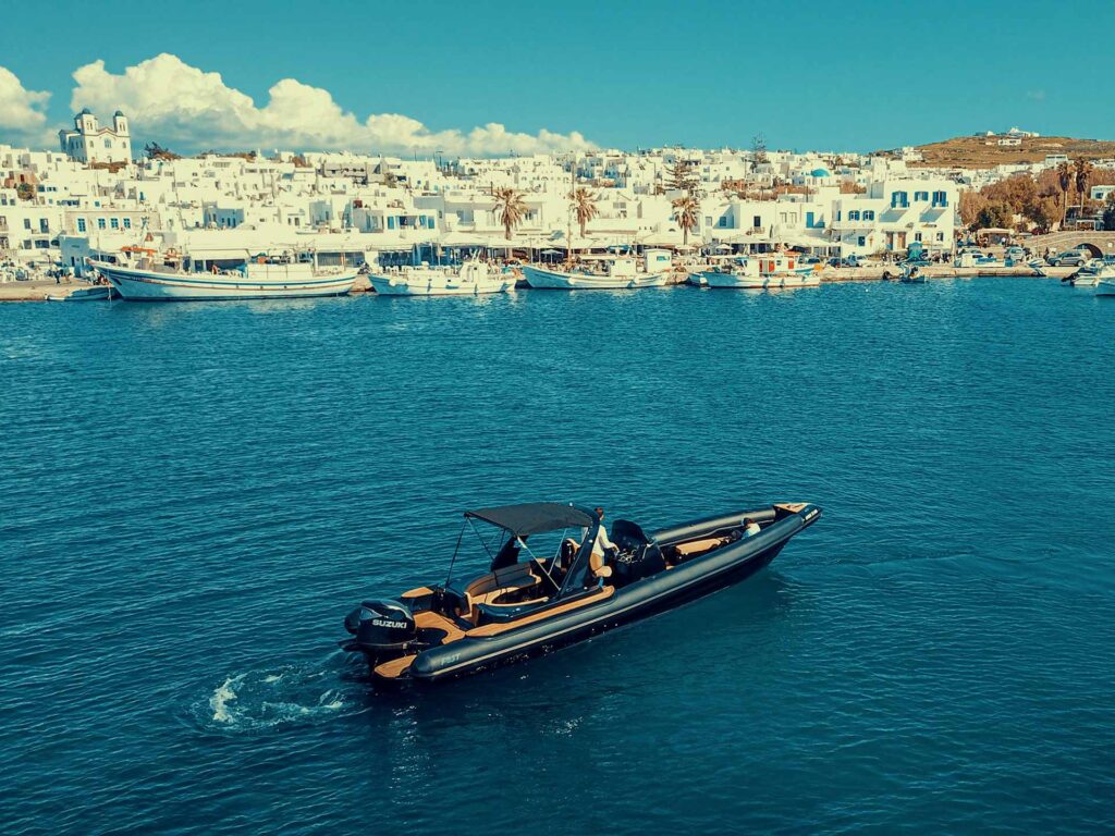 A stunning panoramic view of the whitewashed village from the deck, a must-see perspective when you visit Naousa Paros by private boat.