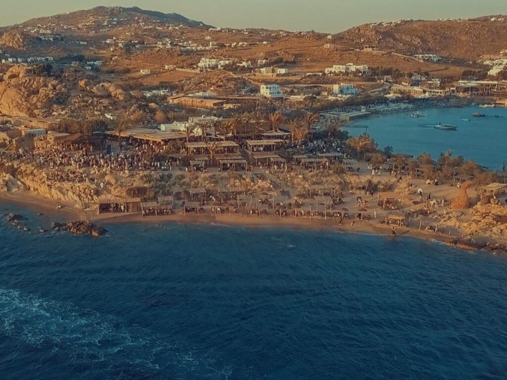 Sunset drone view at Scorpios Mykonos, one of the best Mykonos beach clubs by boat.