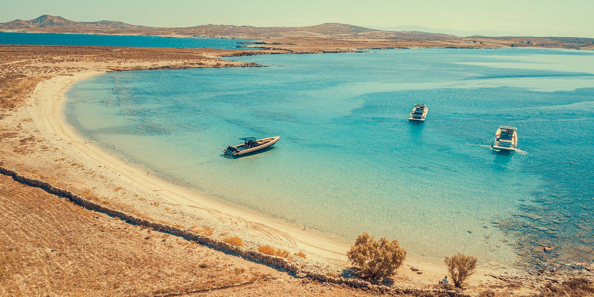 The green spring landscape of Rhenia island during Easter in Mykonos.