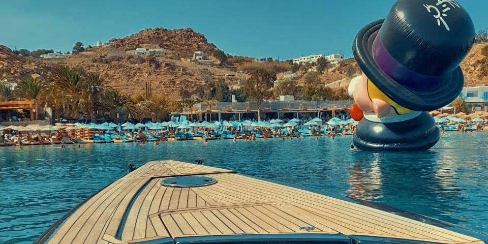 Panoramic view of Psarou beach and famous Nammos club Mykonos restaurants by boat