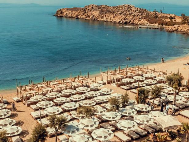 Aerial perspective showing the immense saltwater pool at SantAnna Parties 2026 and the crystal-clear Aegean waters.