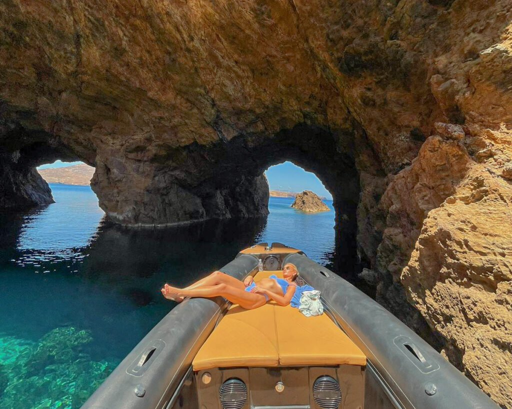 A luxury RIB boat navigating inside the famous sea caves of Dragonisi island near Mykonos