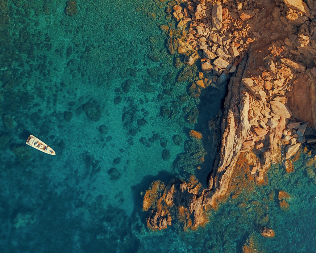 Panoramic view of the dramatic rocky cliffs and turquoise waters during a Dragonisi Mykonos Tour