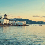 The iconic windmills of Mykonos bathed in golden sunset light — a timeless view that looks best when you've spent the day on a Don Blue Yachting private cruise during the best time to visit Mykonos