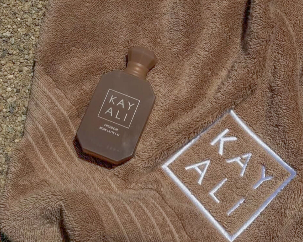 A KAYALI branded beach towel with a Freedom Collection fragrance on display during the Kayali event Greece in Tinos