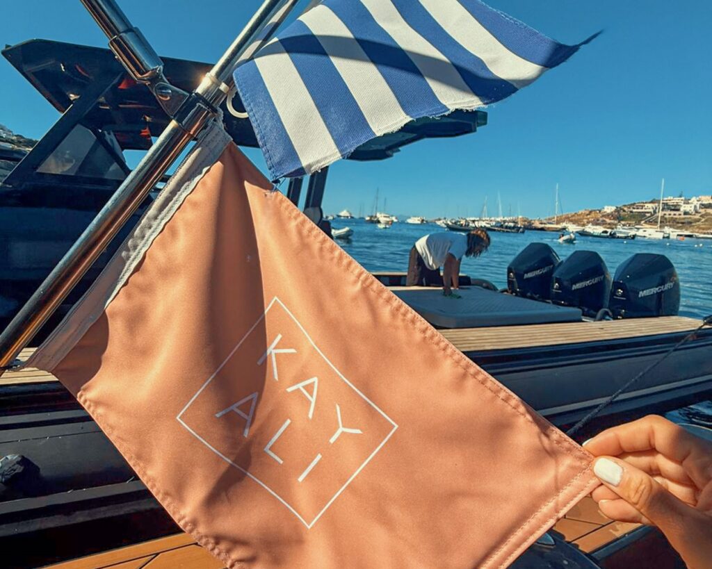 Don Blue Yachting boats decorated with KAYALI branded flags for the sea transfer during the Kayali event Greece