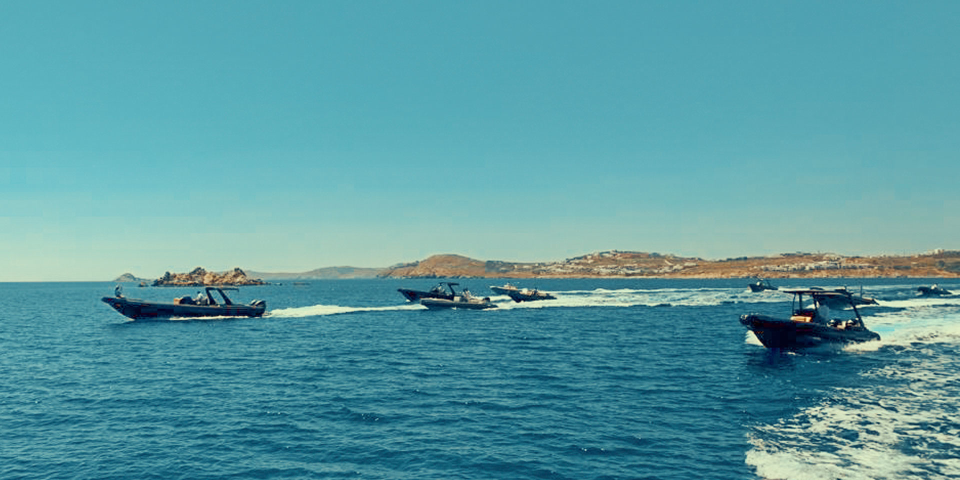 Don Blue Yachting private boats lined up for a VIP sea transfer — the slickest way to avoid crowds in Mykonos.