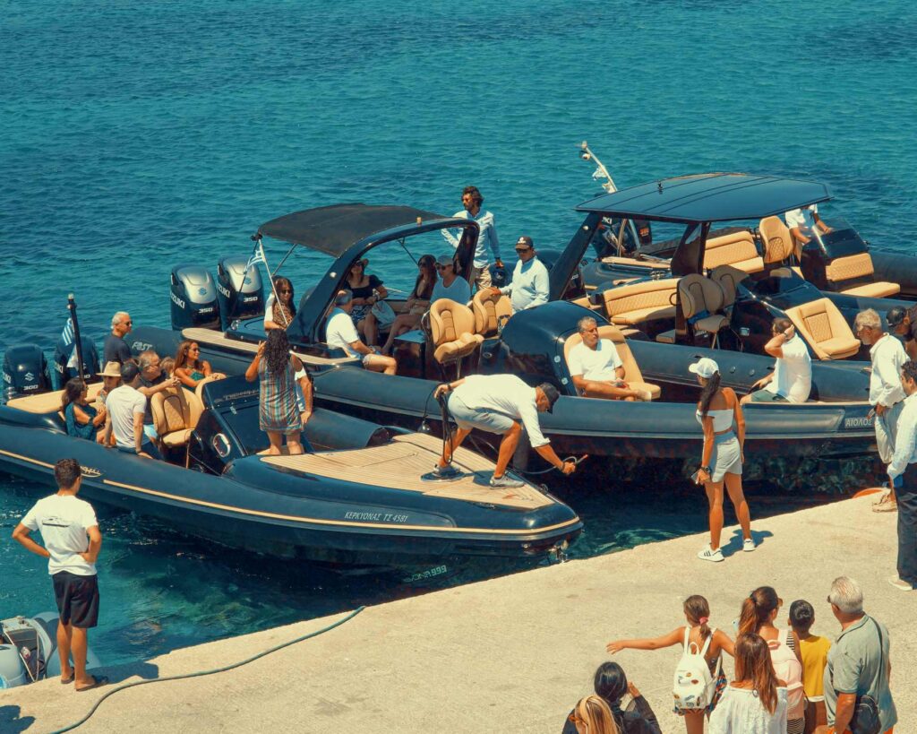 Don Blue Yachting private boats lined up at Ornos dock Mykonos boarding guests for a VIP sea transfer — the slickest way to avoid crowds in Mykonos before the roads even wake up.