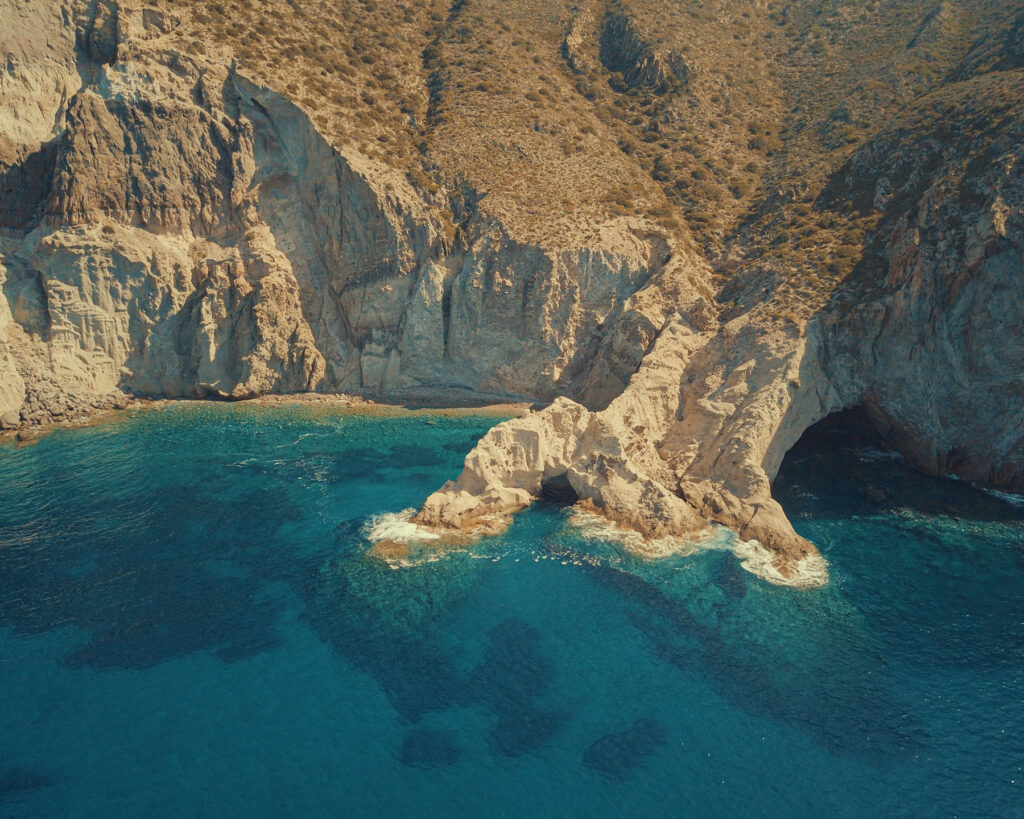 Aerial drone view of the rugged south coast beaches of Antiparos accessible only by boat — one of the hidden highlights of a Don Blue Yachting private cruise from Paros in Greece