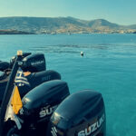 Don Blue Yachting boats docked at Crios Beach Paros with the EXPLORA II anchored in the background during the Ferrari Cavalcade 2026 Greece transfer operation
