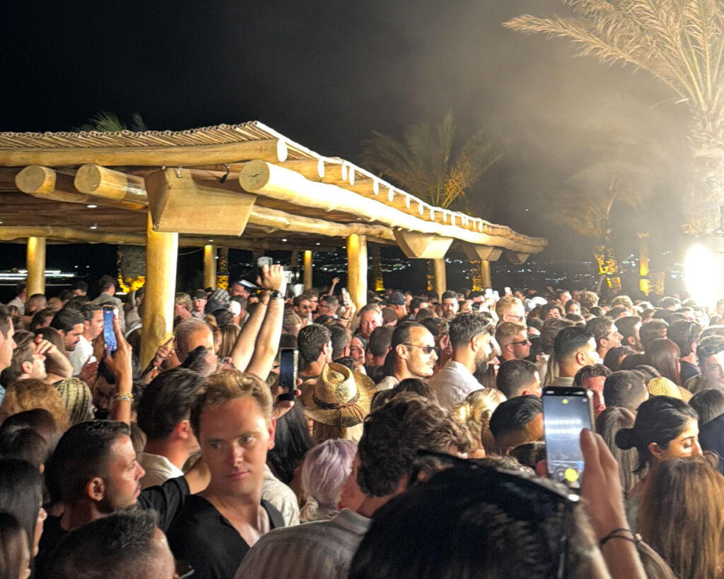 A packed crowd inside Scorpios Mykonos during the sold-out Peggy Gou Music Ritual on July 21 2026 — with Don Blue Yachting handling the VIP sea transfers for the night