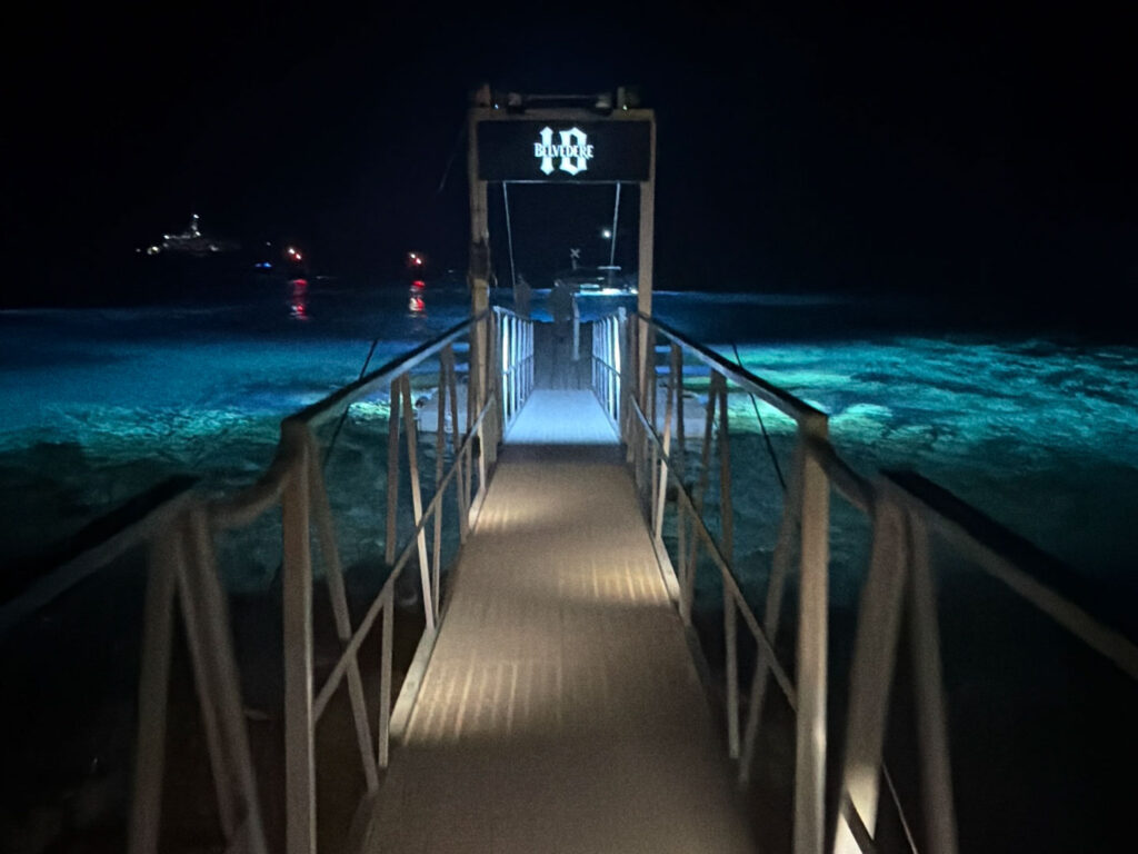 The iconic floating entrance of Scorpios Mykonos seen from the water on the night of the Rampa Music Ritual with Don Blue Yachting sea transfer service