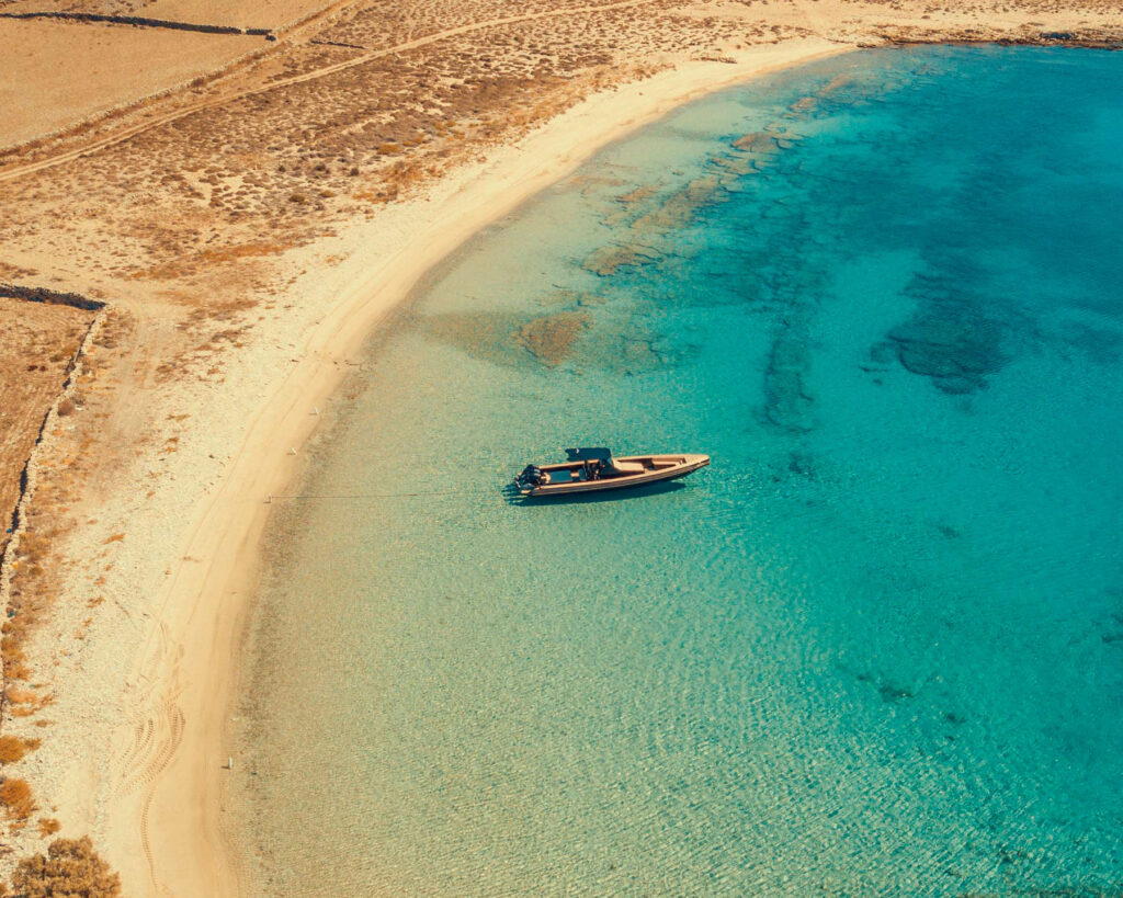 Turquoise waters of Rhenia island near Mykonos on a Don Blue Yachting Steve Aoki private cruise