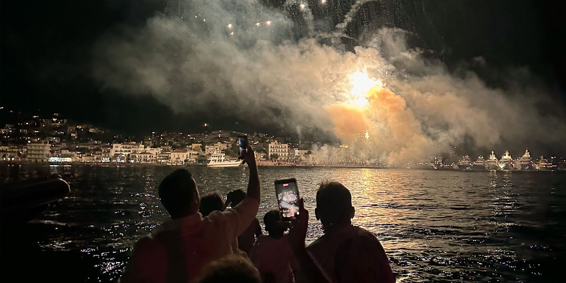 The burning replica Ottoman flagship and fireworks display during the Armata Spetses festival watched from a Don Blue Yachting private boat